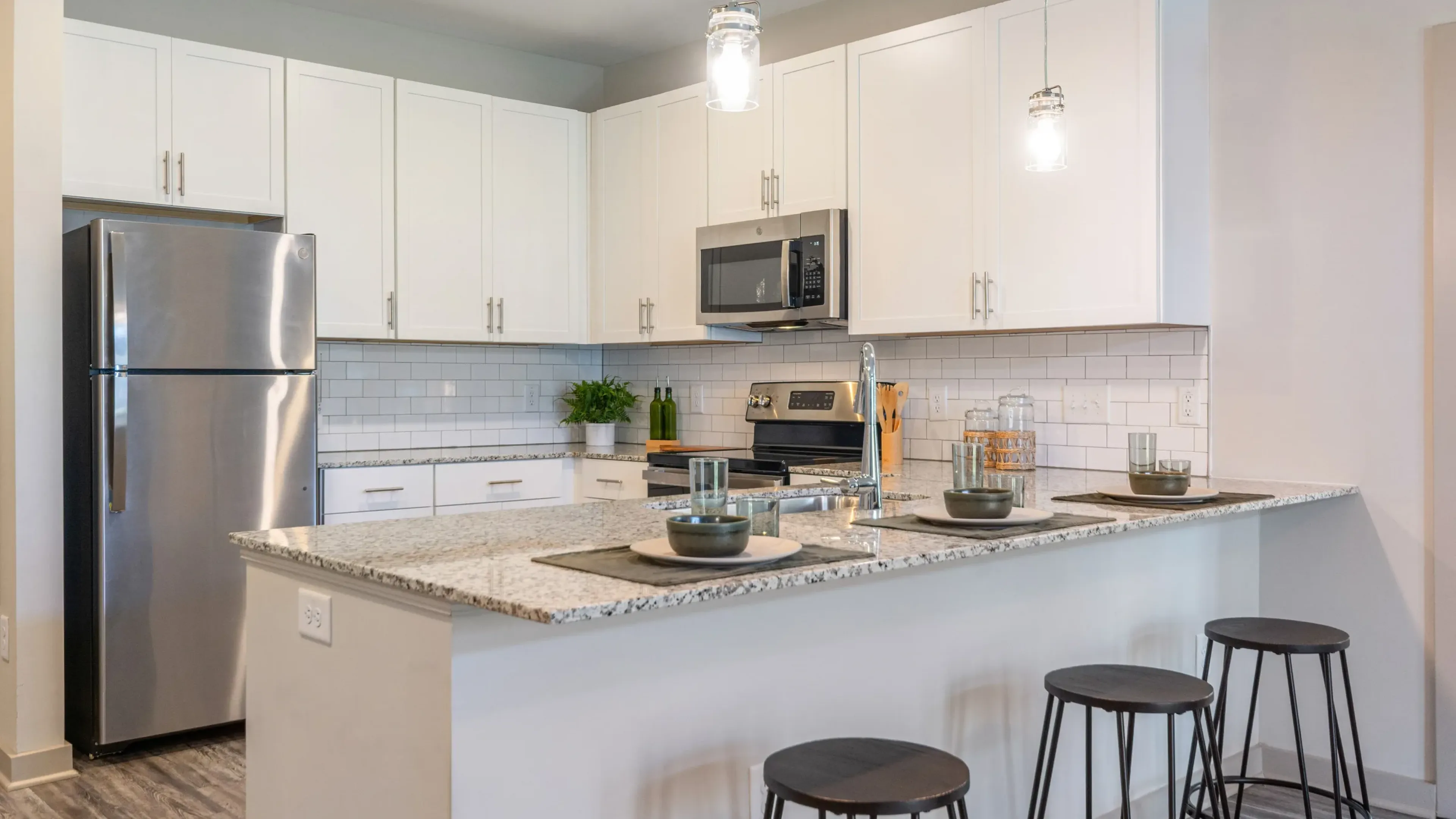 Hawthorne at St. Marks outdoor firepit looking over pool and grill area.