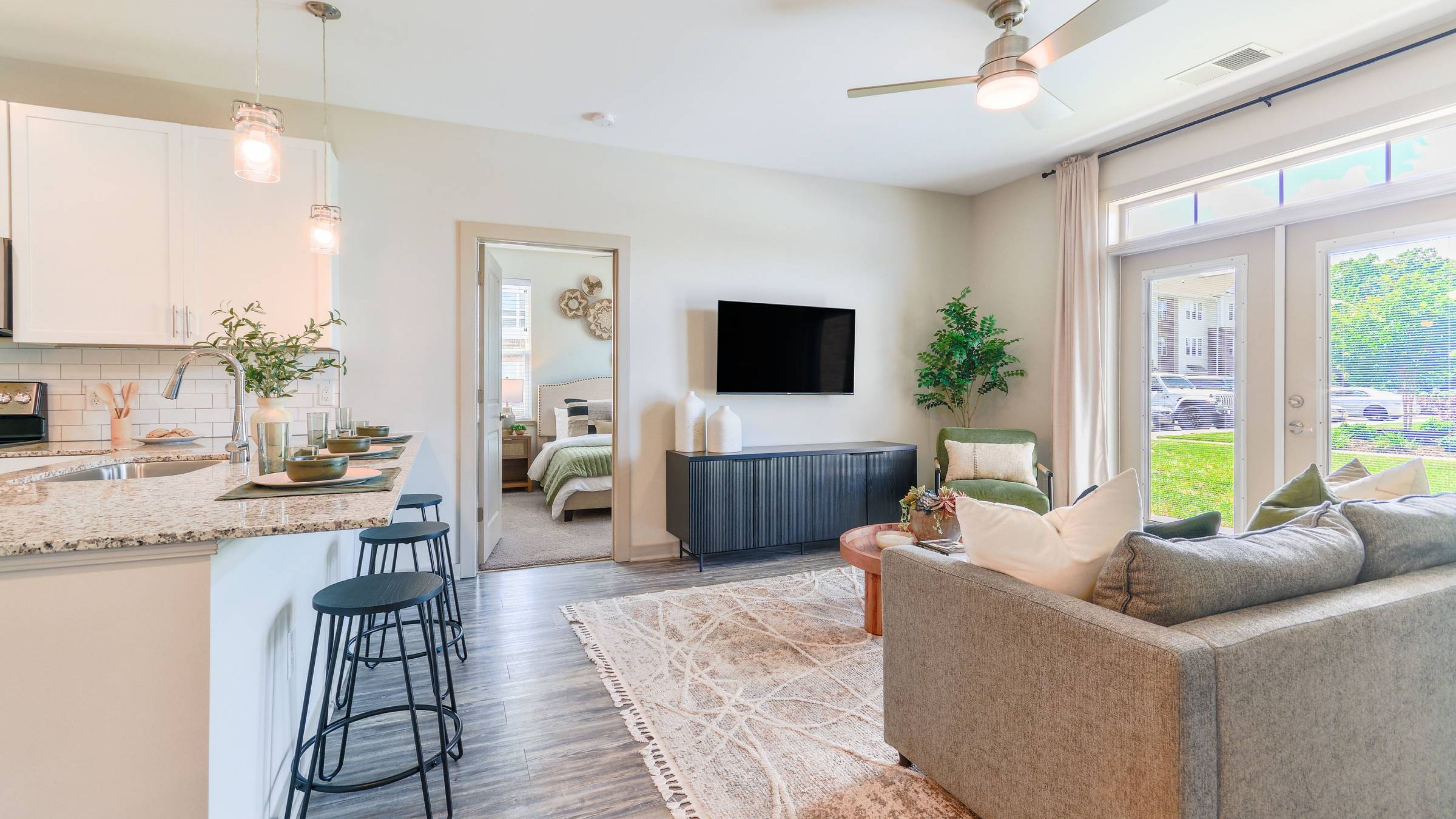 A bright and cozy kitchen at Hawthorne at St. Marks with white cabinets and stainless steel appliances.
